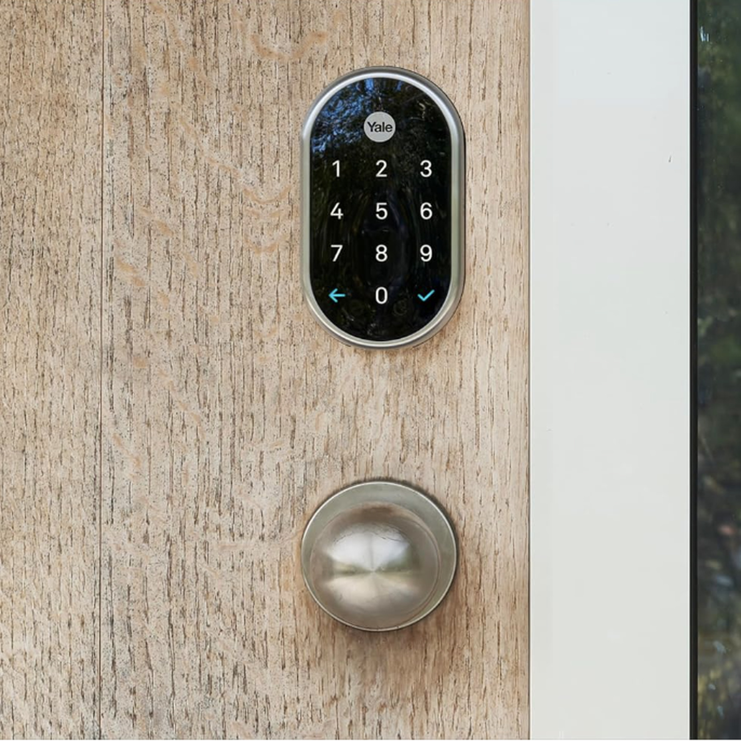 Black smart lock on a door above a doorknob