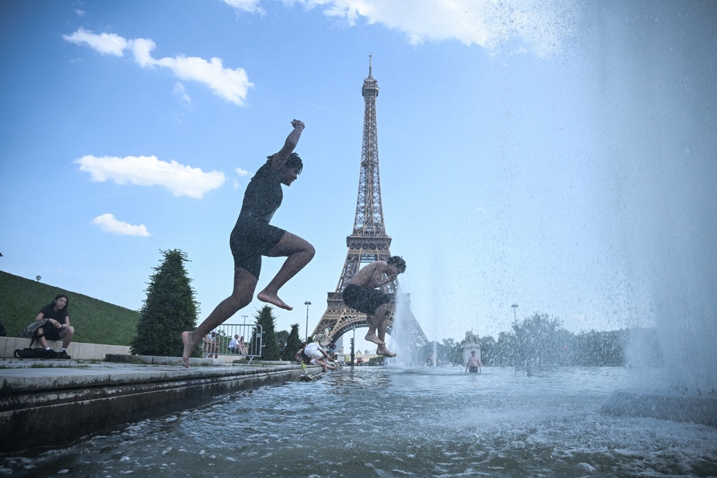 Người dân tránh nóng ở đài phun nước Trocadero dưới chân Tháp Eiffel, Paris, ngày 22/6. Ảnh: AFP